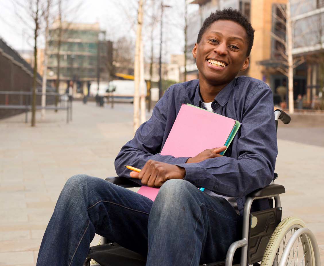 student in wheelchair, happy, holding folder