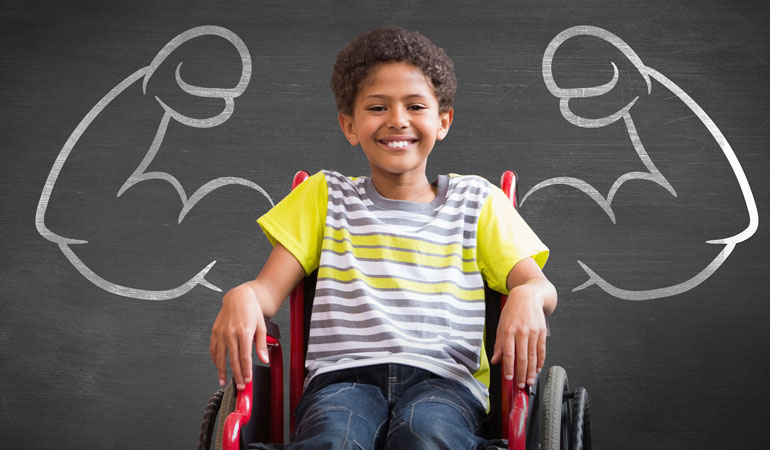 child in wheelchair with chalkboard muscles behind him